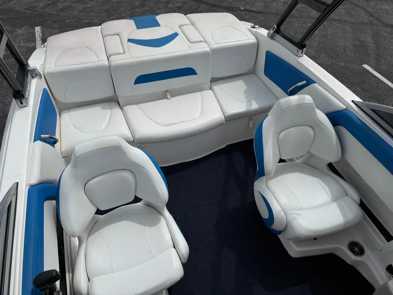 Slide: The Image of 2017 Chaparral 19 H2O Sport boat interior with white and blue seating. - 25