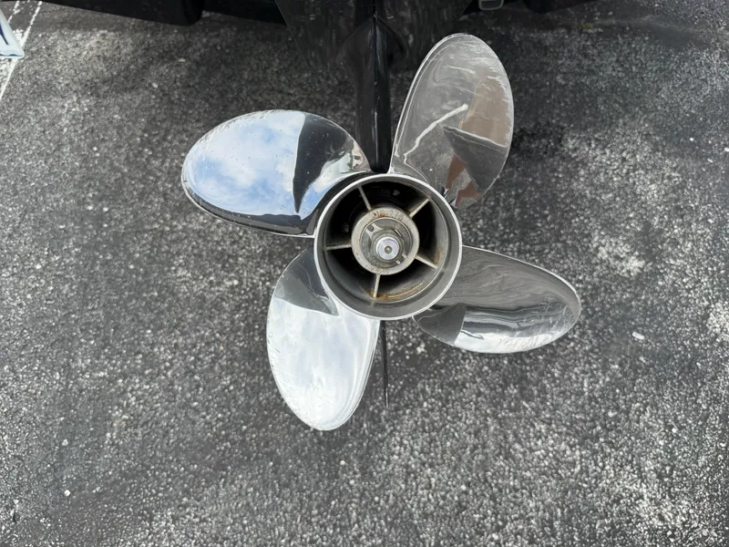 Slide: The Image of Close-up of a 2017 Chaparral 19 H2O Sport boat propeller on asphalt. - 26