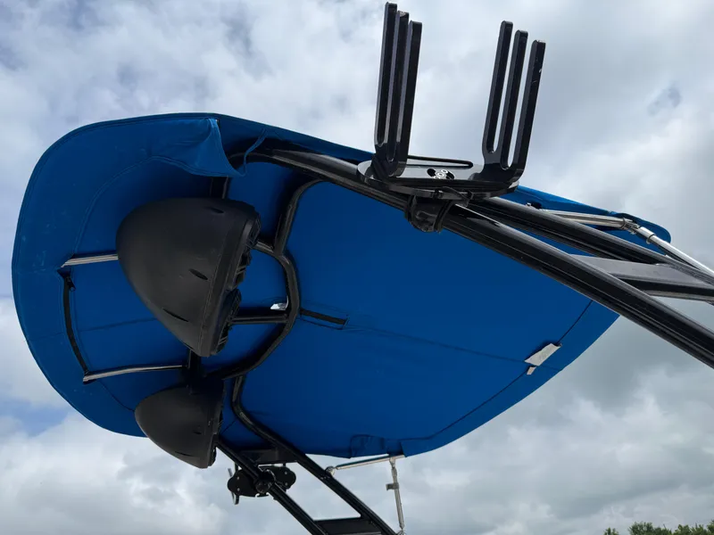 Slide: The Image of 2017 Chaparral 19 H2O Sport boat with blue canopy and wakeboard rack. - 27