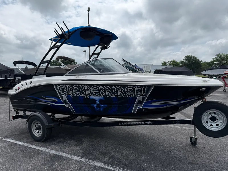 Slide: The Image of 2017 Chaparral 19 H2O Sport boat with custom graphics on a trailer. - 3