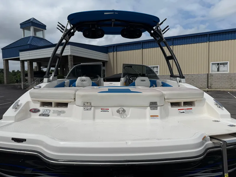 Slide: The Image of 2017 Chaparral 19 H2O Sport boat, rear view, parked near a building. - 30