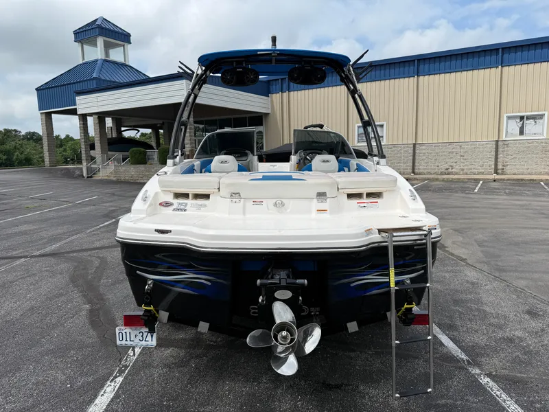 Slide: The Image of 2017 Chaparral 19 H2O Sport boat, rear view, parked in lot near building. - 31