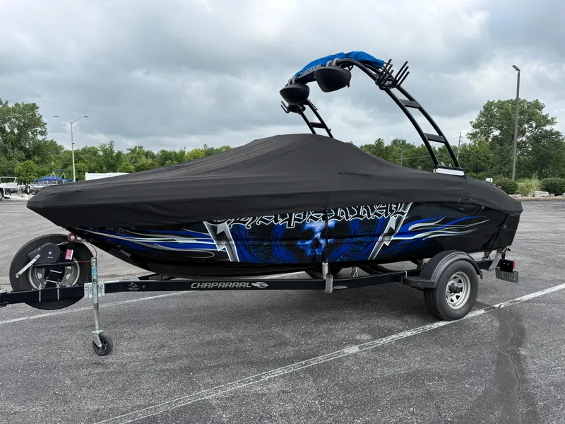 Slide: The Image of 2017 Chaparral 19 H2O Sport boat with cover on trailer, parked outdoors. - 4