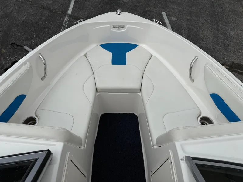 Slide: The Image of 2017 Chaparral 19 H2O Sport boat interior with white and blue seating. - 9