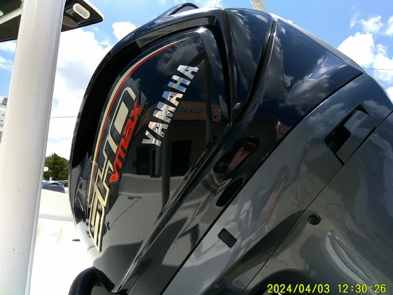 Slide: The Image of Yamaha VMAX engine on 2023 NauticStar 231 Hybrid boat, under clear blue sky. - 17