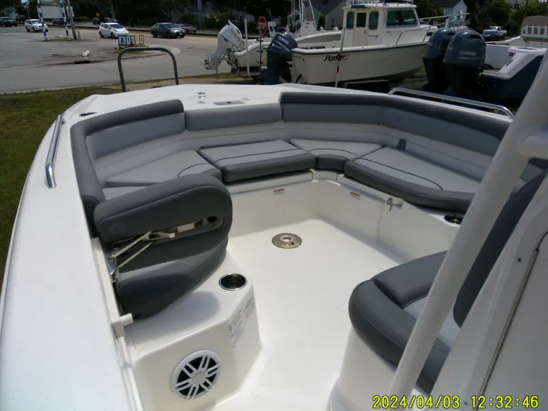 Slide: The Image of 2023 NauticStar 231 Hybrid boat interior with gray seating and cup holders. - 18