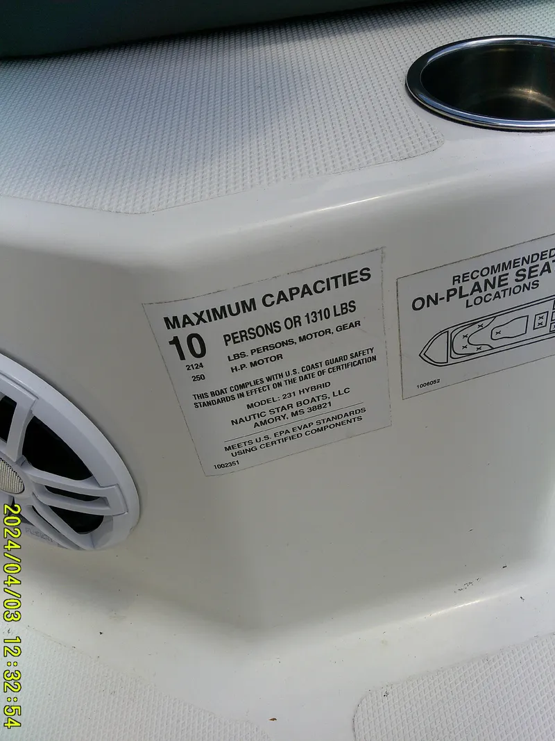 Slide: The Image of 2023 NauticStar 231 Hybrid boat capacity label, seating diagram, and speaker detail. - 19
