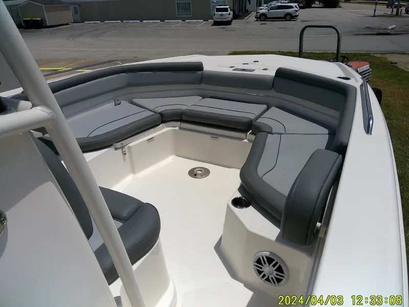 Slide: The Image of 2023 NauticStar 231 Hybrid boat interior with gray seating and cup holders. - 21
