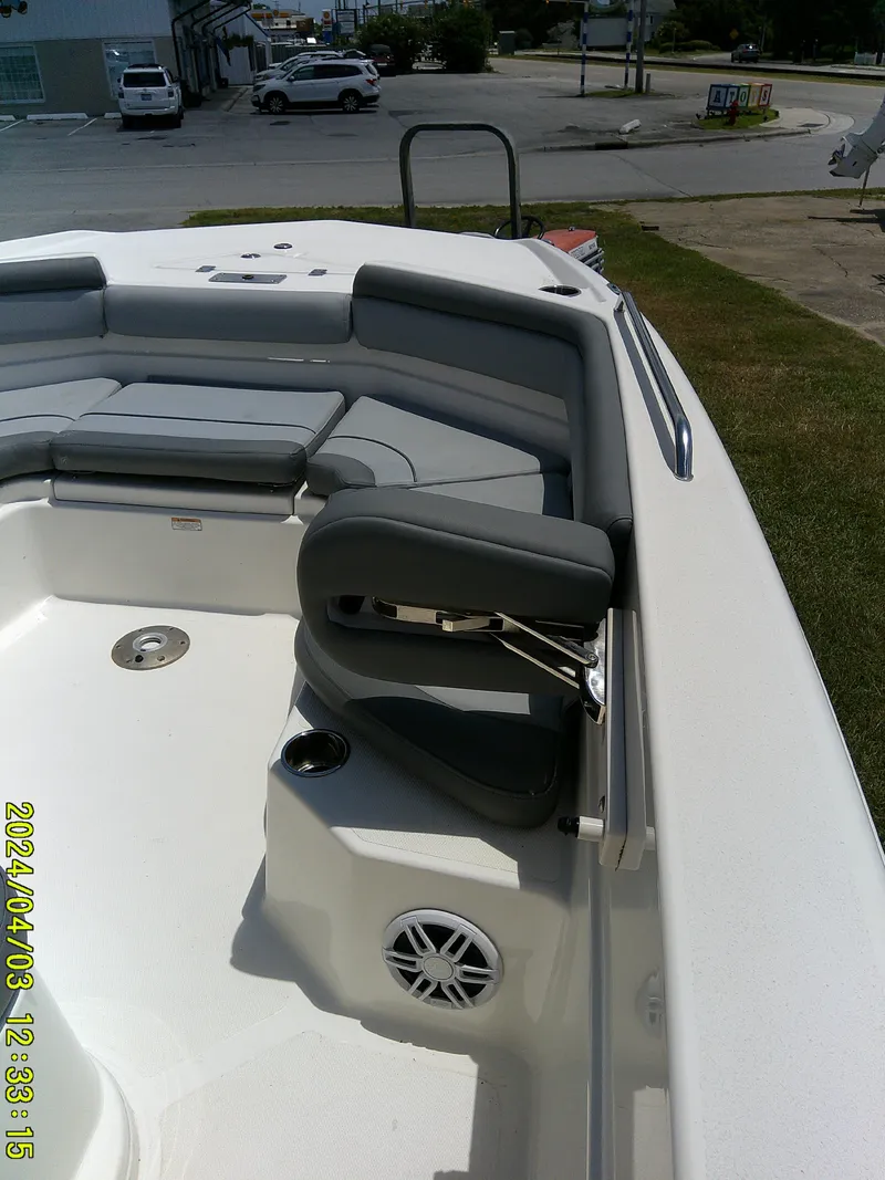 Slide: The Image of 2023 NauticStar 231 Hybrid boat interior with gray seating and cup holder. - 22