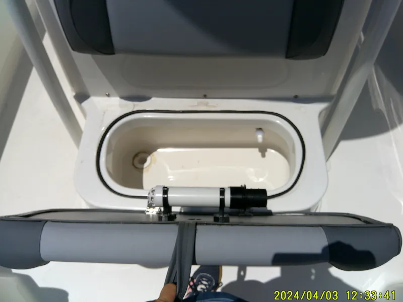 Slide: The Image of 2023 NauticStar 231 Hybrid boat storage compartment with padded seating. - 27