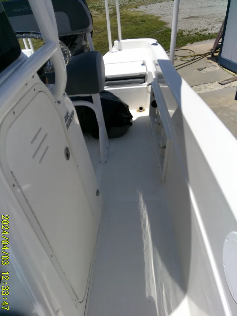 Slide: The Image of 2023 NauticStar 231 Hybrid boat interior with seating and storage compartments. - 28