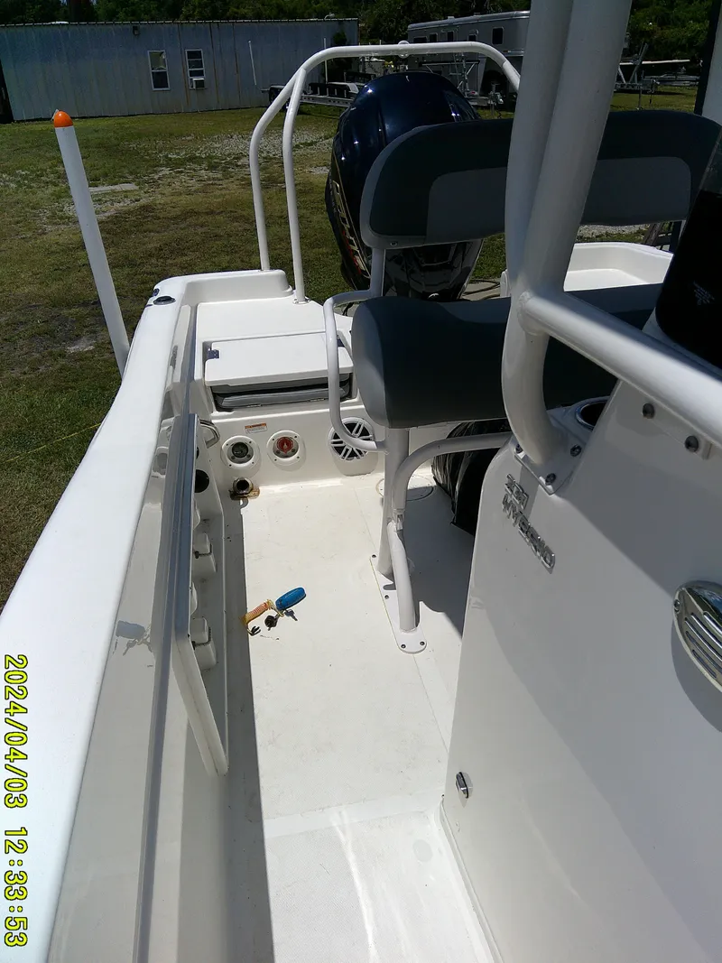 Slide: The Image of 2023 NauticStar 231 Hybrid boat interior with seating and controls. - 29