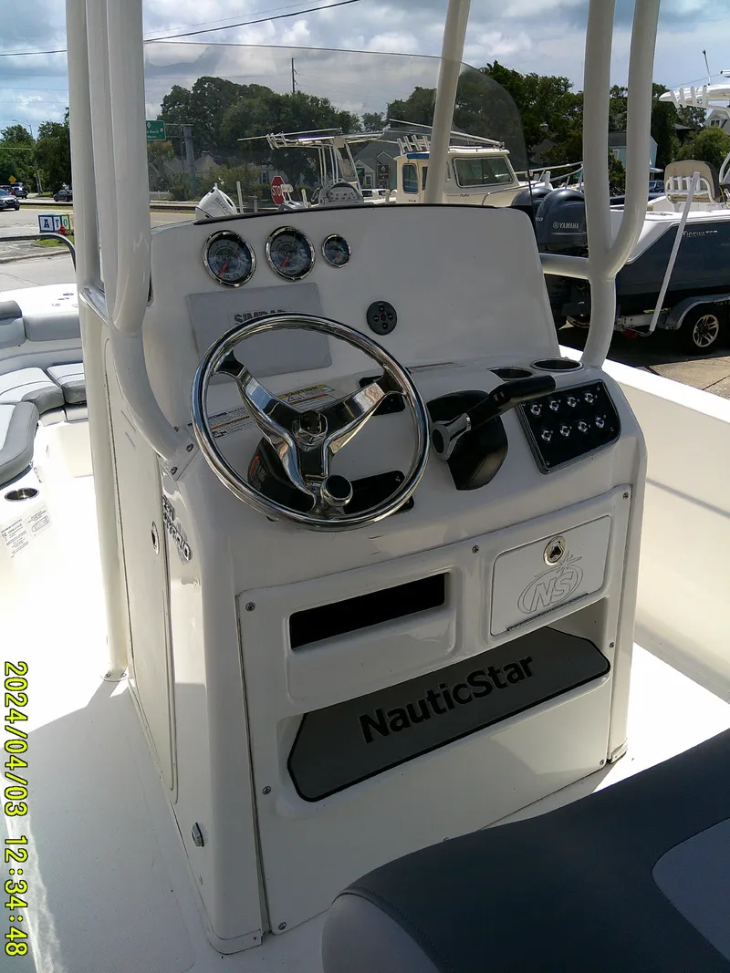 Slide: The Image of 2023 NauticStar 231 Hybrid boat console with steering wheel and gauges. - 37