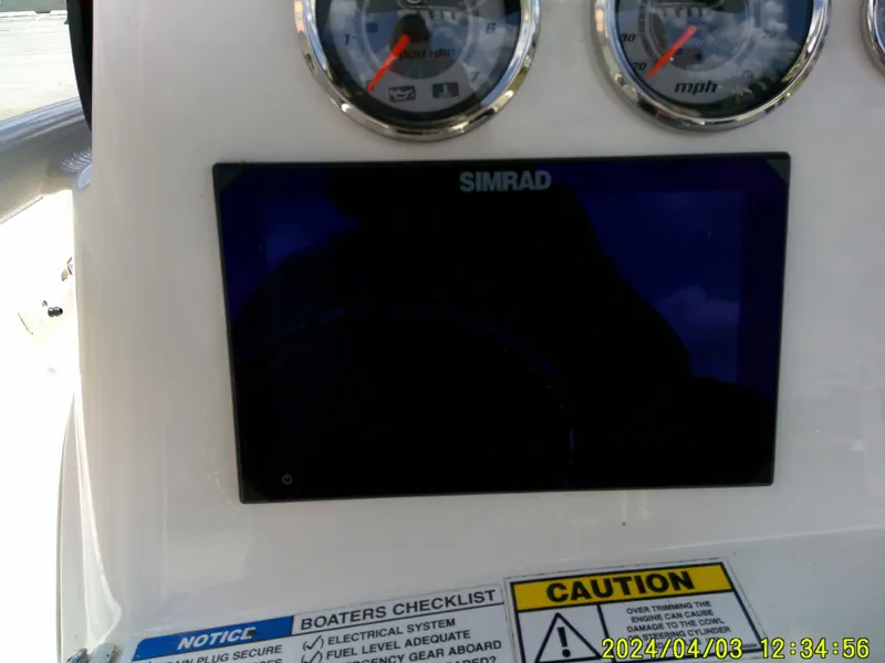 Slide: The Image of Dashboard of 2023 NauticStar 231 Hybrid boat with Simrad display and gauges. - 38