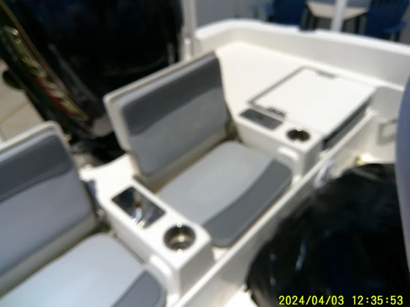 Slide: The Image of 2023 NauticStar 231 Hybrid boat interior with gray seating and cup holders. - 43