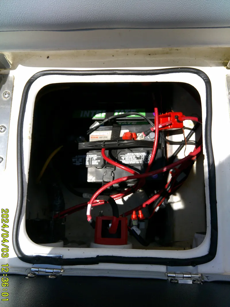 Slide: The Image of Battery compartment of 2023 NauticStar 231 Hybrid boat with visible wiring. - 44