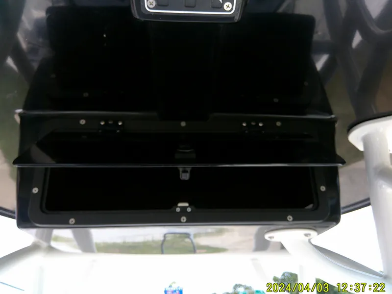 Slide: The Image of 2023 NauticStar 231 Hybrid boat console with open storage compartment. - 47