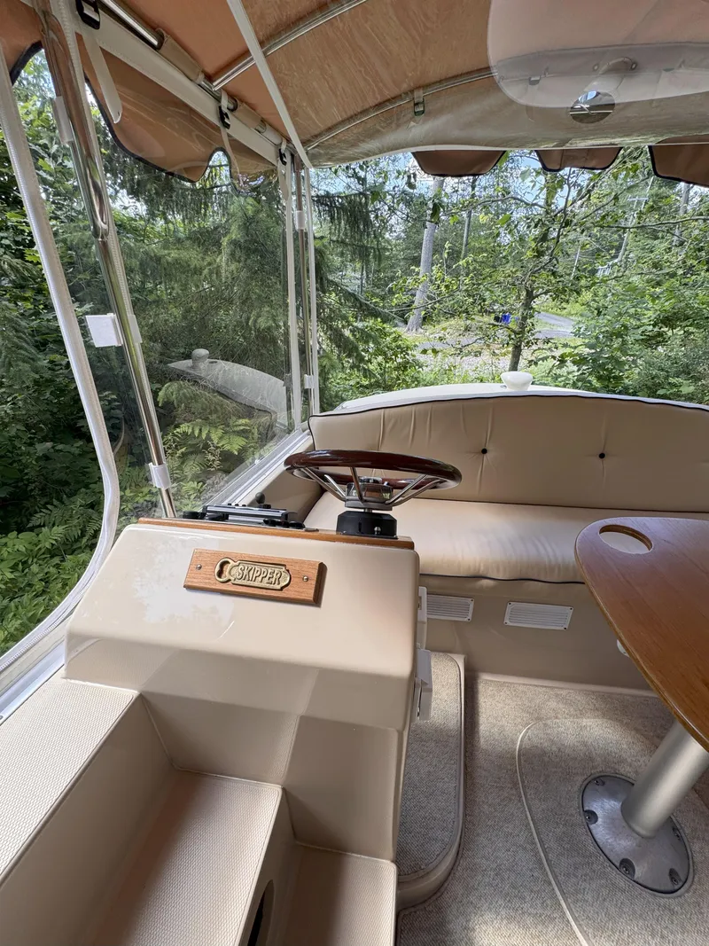 Slide: The Image of Interior of 2008 Duffy Snug Harbor 18 boat with steering wheel and seating. - 5