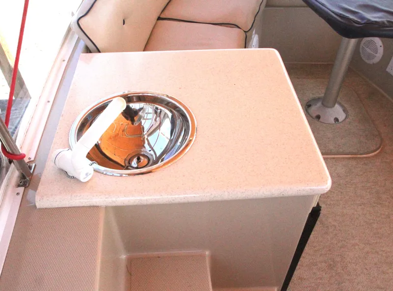 Slide: The Image of Interior of 2008 Duffy Snug Harbor 18 boat with sink and seating area. - 9