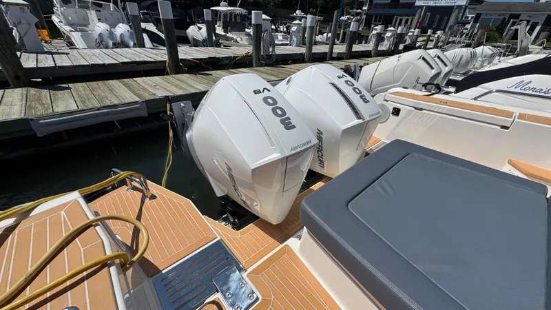 Slide: The Image of Twin Mercury 300 V8 engines on a 2024 Nimbus W11 boat docked at a marina. - 10