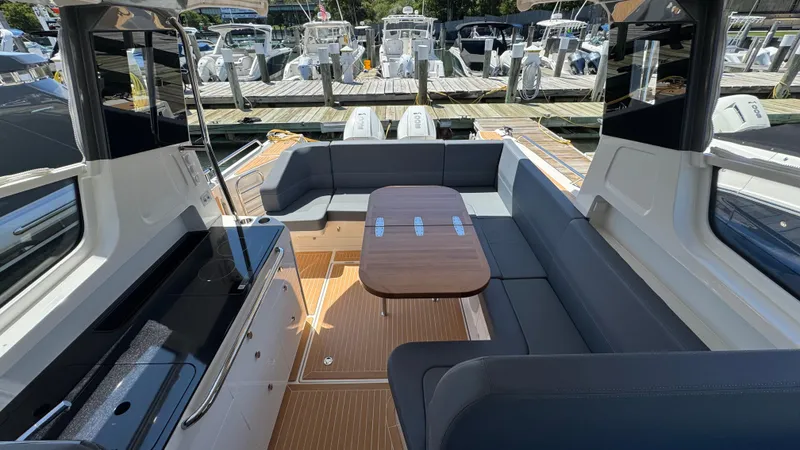 Slide: The Image of Luxurious 2024 Nimbus W11 boat interior with sleek seating and elegant wooden table. - 18