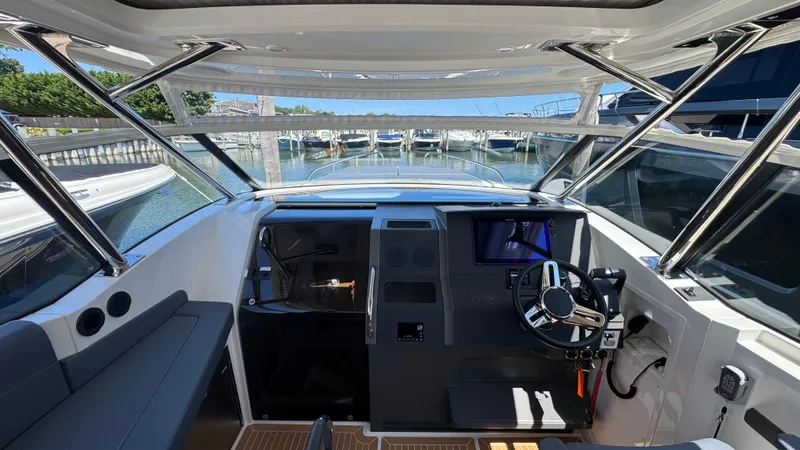 Slide: The Image of 2024 Nimbus W11 boat cockpit with modern steering and navigation system. - 22