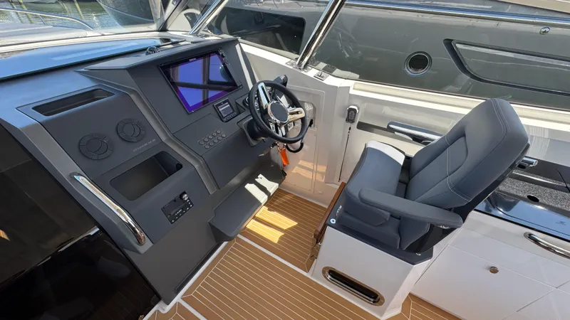Slide: The Image of Helm of 2024 Nimbus W11 boat with modern controls and comfortable seating. - 23