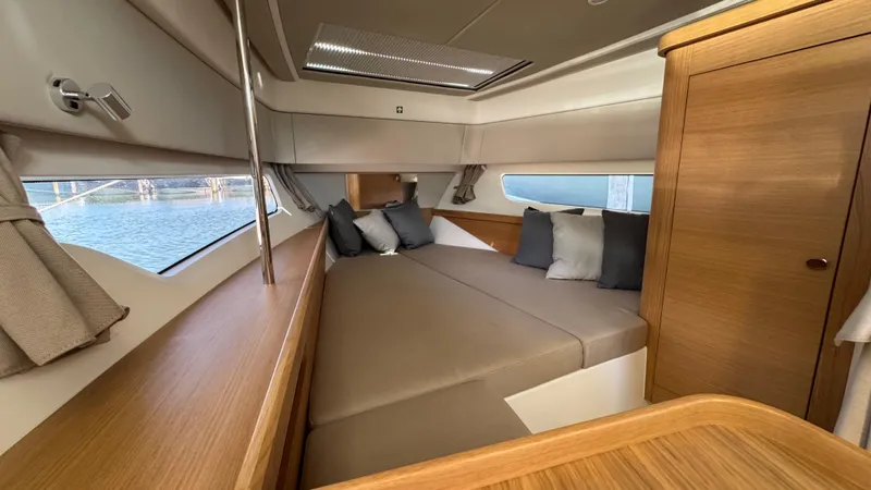 Slide: The Image of Luxurious interior cabin of 2024 Nimbus W11 yacht with cozy bedding and wooden finishes. - 30