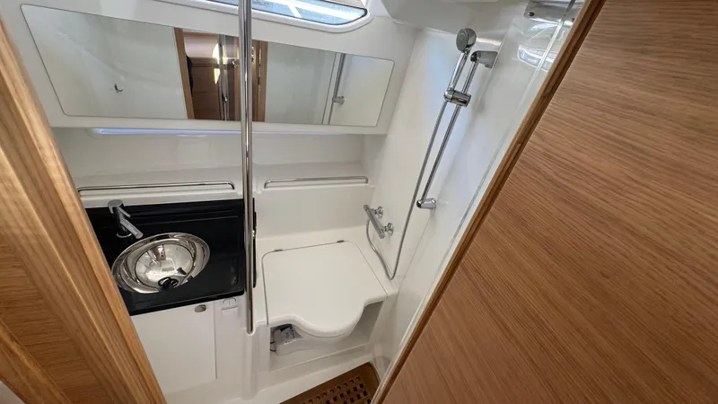 Slide: The Image of 2024 Nimbus W11 boat bathroom with sink, toilet, and shower in compact, modern design. - 33