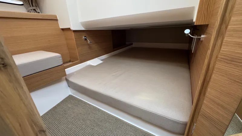 Slide: The Image of 2024 Nimbus W11 cabin interior with wooden finish and cozy sleeping area. - 35