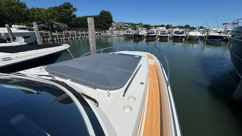 Slide: The Image of 2024 Nimbus W11 boat docked in a marina, featuring sleek design and spacious deck. - 39