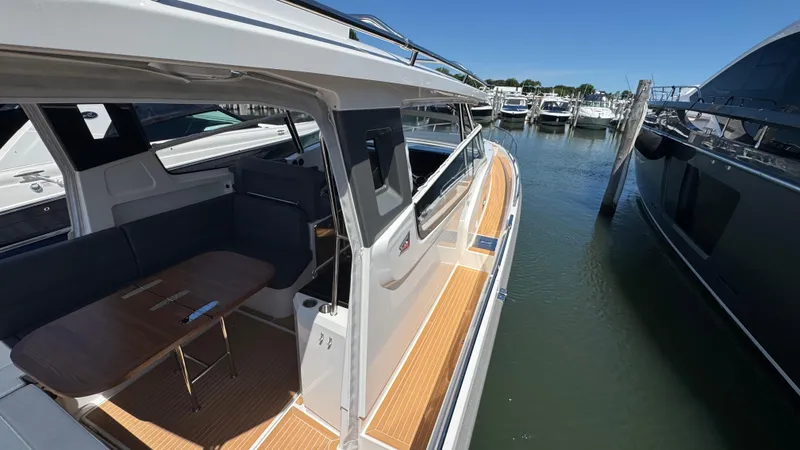 Slide: The Image of 2024 Nimbus W11 yacht docked, showcasing sleek design and spacious interior seating area. - 40