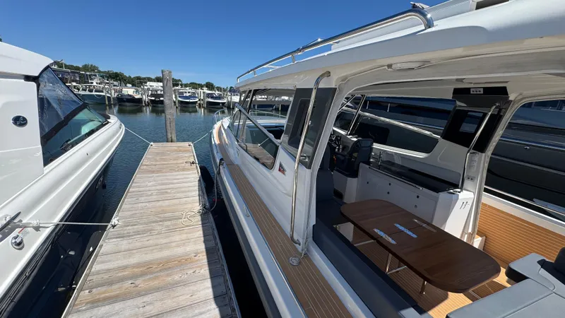 Slide: The Image of 2024 Nimbus W11 yacht docked at marina, showcasing sleek design and spacious interior. - 41
