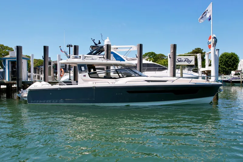Slide: The Image of 2024 Nimbus W11 boat docked at marina under clear blue sky. - 5