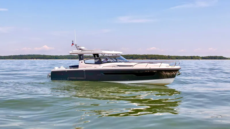 The Image of 2024 Nimbus W11 boat cruising on calm waters under a clear sky. - 0