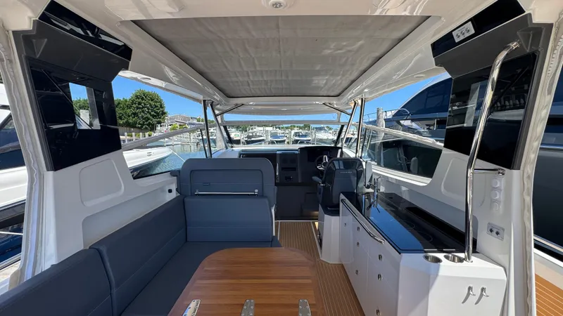 Slide: The Image of 2024 Nimbus W11 boat interior with sleek seating, modern helm, and spacious layout. - 16