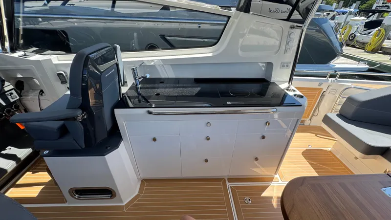 Slide: The Image of Luxurious interior of 2024 Nimbus W11 yacht featuring sleek kitchenette and modern seating. - 21