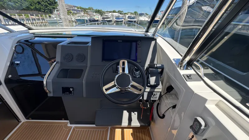Slide: The Image of Helm of 2024 Nimbus W11 boat with modern controls and steering wheel. - 24
