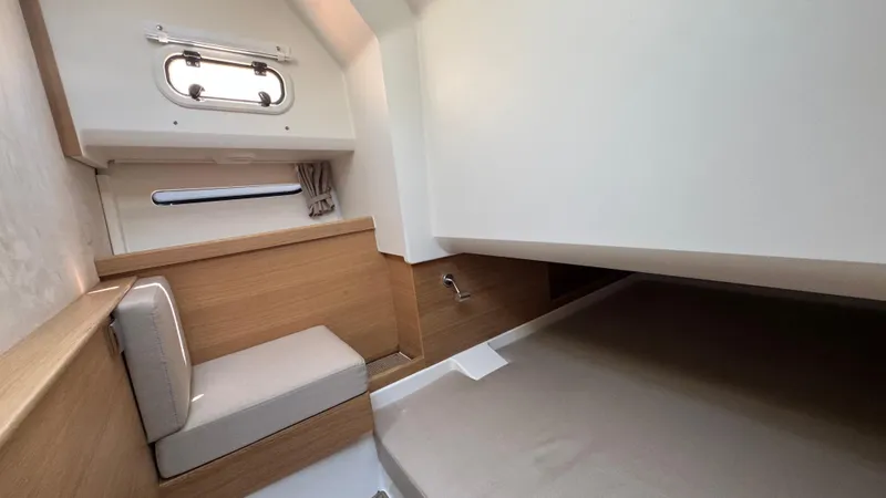 Slide: The Image of 2024 Nimbus W11 cabin interior with wooden accents and seating. - 34