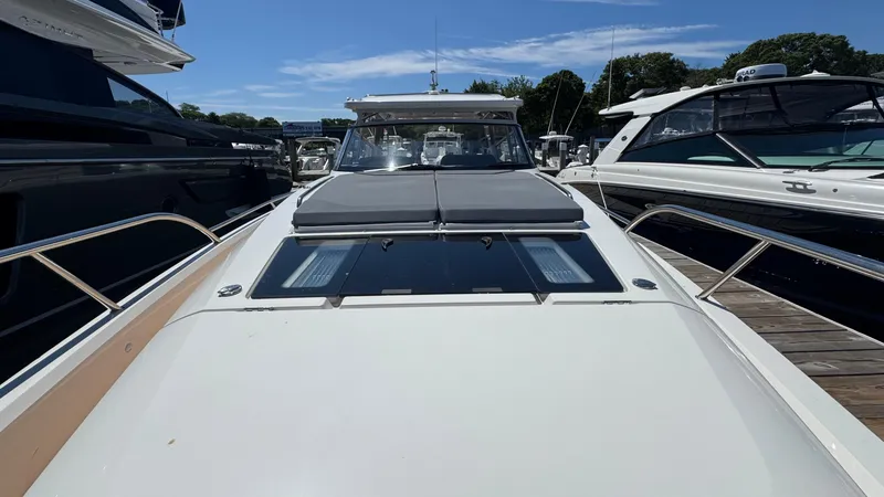 Slide: The Image of 2024 Nimbus W11 yacht docked, showcasing sleek design and spacious deck under clear blue sky. - 36