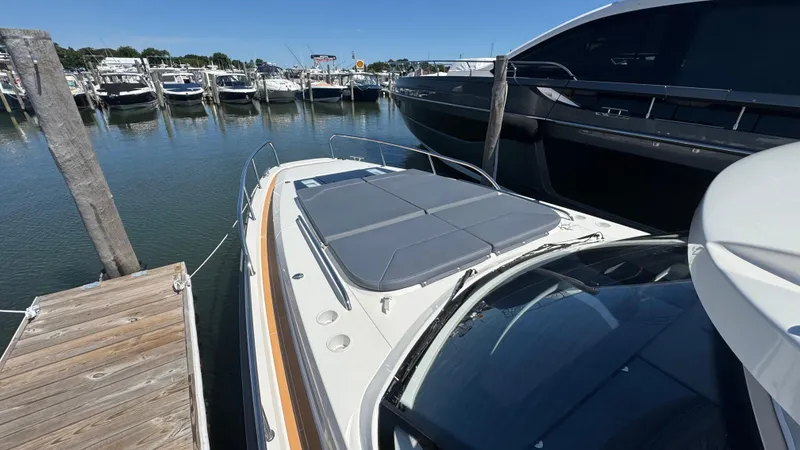 Slide: The Image of 2024 Nimbus W11 yacht docked at marina, surrounded by other boats under clear blue sky. - 37