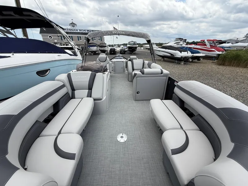 Slide: The Image of 2025 Sylvan L3 Party Fish pontoon boat with spacious seating and modern design at a marina. - 10