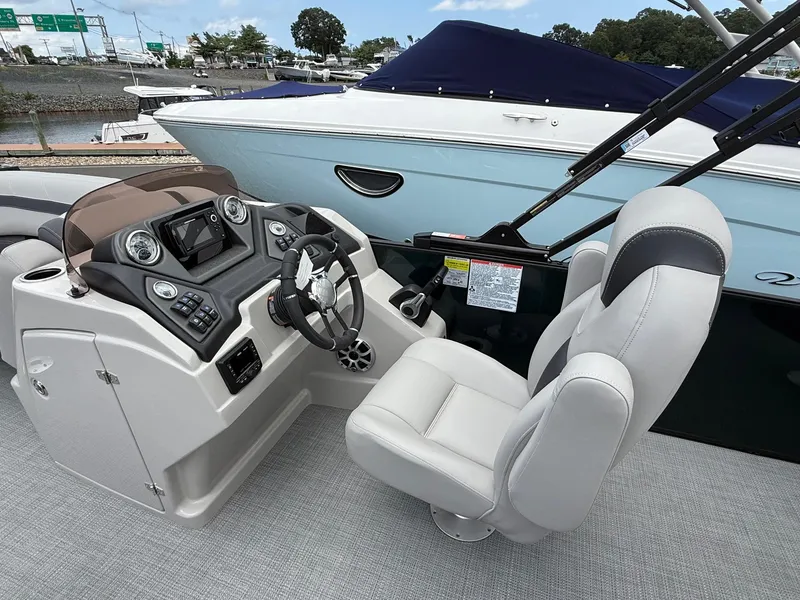 Slide: The Image of 2025 Sylvan L3 Party Fish boat cockpit with modern controls and comfortable seating. - 12