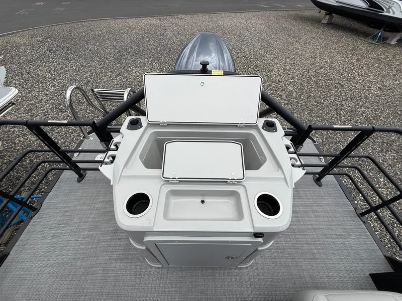 Slide: The Image of 2025 Sylvan L3 Party Fish boat with open storage compartments and cup holders. - 16