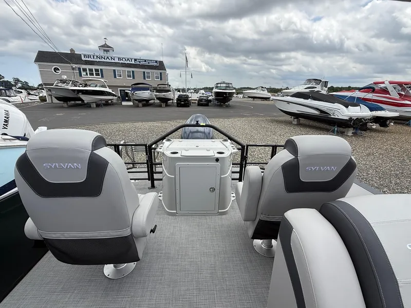 Slide: The Image of 2025 Sylvan L3 Party Fish boat interior at marina, featuring comfortable seating and modern design. - 17