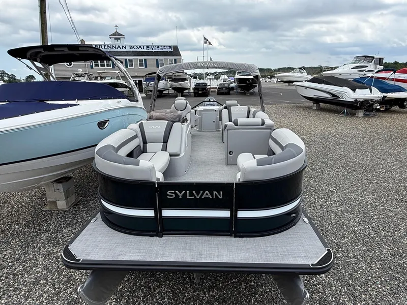 Slide: The Image of 2025 Sylvan L3 Party Fish pontoon boat displayed at a marina with other boats. - 4