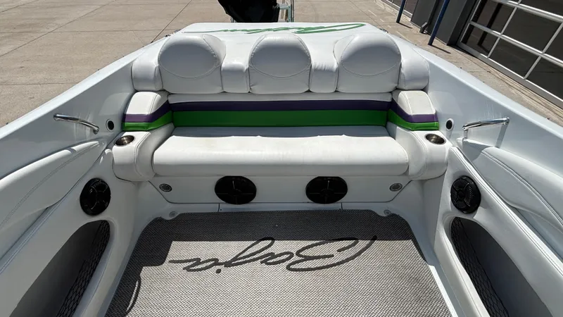 Slide: The Image of 2005 Baja 33 Outlaw boat interior with white seating and colorful accents. - 10