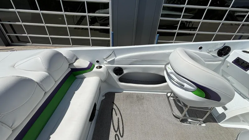 Slide: The Image of 2005 Baja 33 Outlaw boat interior with white seating and green accents. - 12