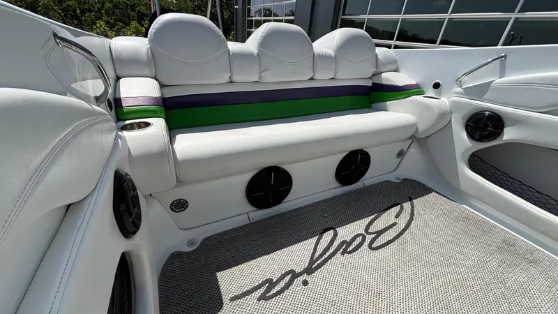 Slide: The Image of 2005 Baja 33 Outlaw boat interior with white seating and colorful accents. - 13