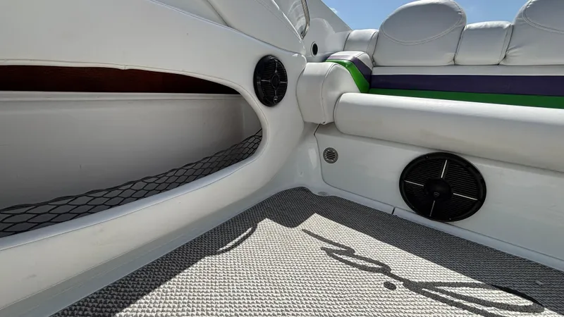 Slide: The Image of Interior of a 2005 Baja 33 Outlaw boat with white seating and speakers. - 14
